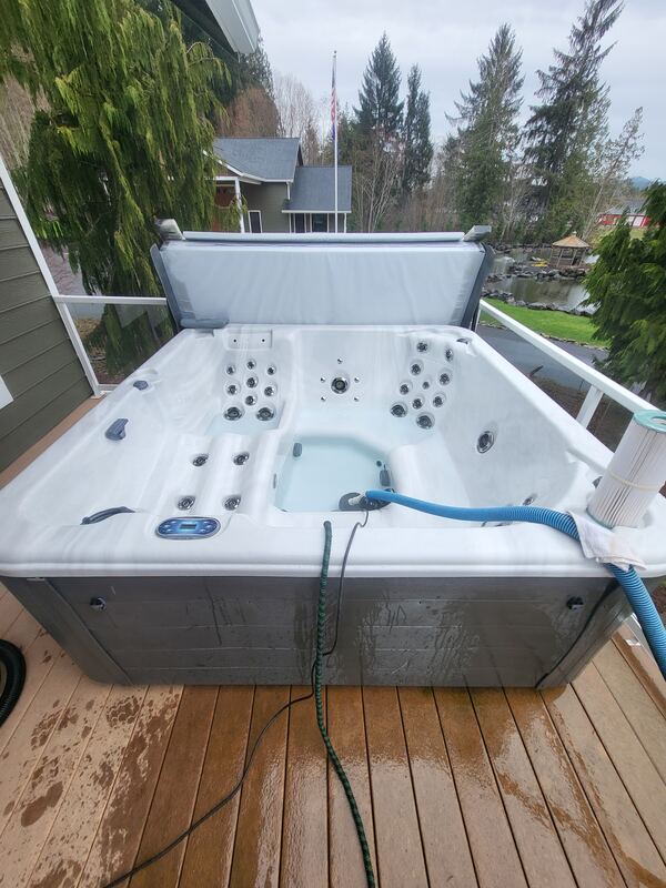 Hot tub drained and being vacuumed mid-service