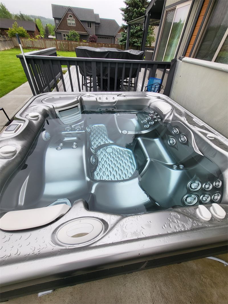 Clean hot tub with still, clear water on a covered patio