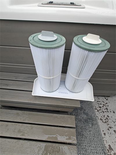 Two freshly cleaned hot tub filter cartridges on a tray