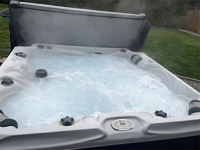 Steam rising from a hot tub with churning clean water