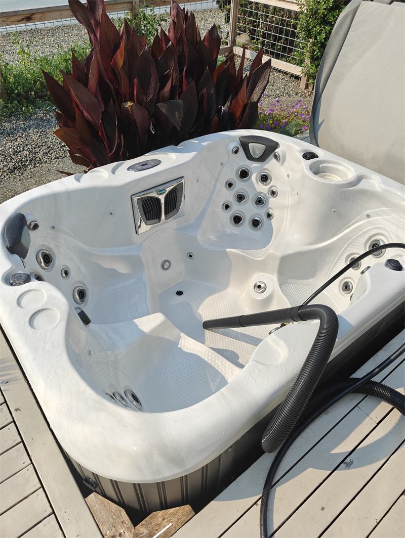 Spotless empty hot tub shell beside the waterfront after cleaning