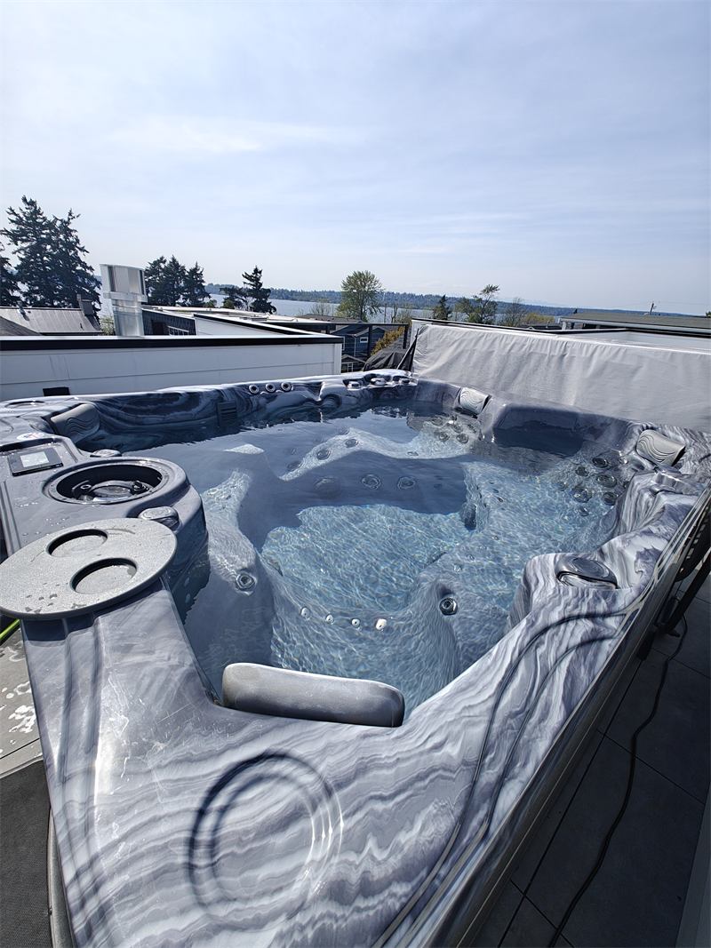 Rooftop hot tub with sparkling clear water and a lake view