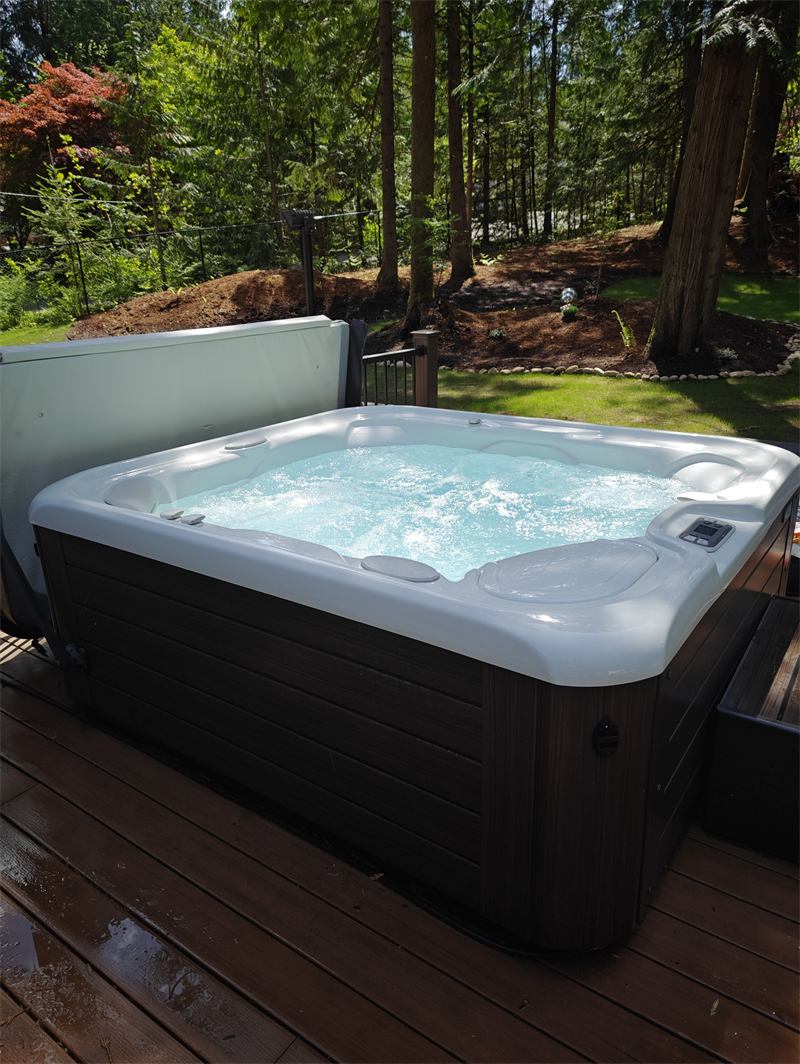 Hot tub with bright aqua water on a sunlit deck after a Hot Tub Shine service visit