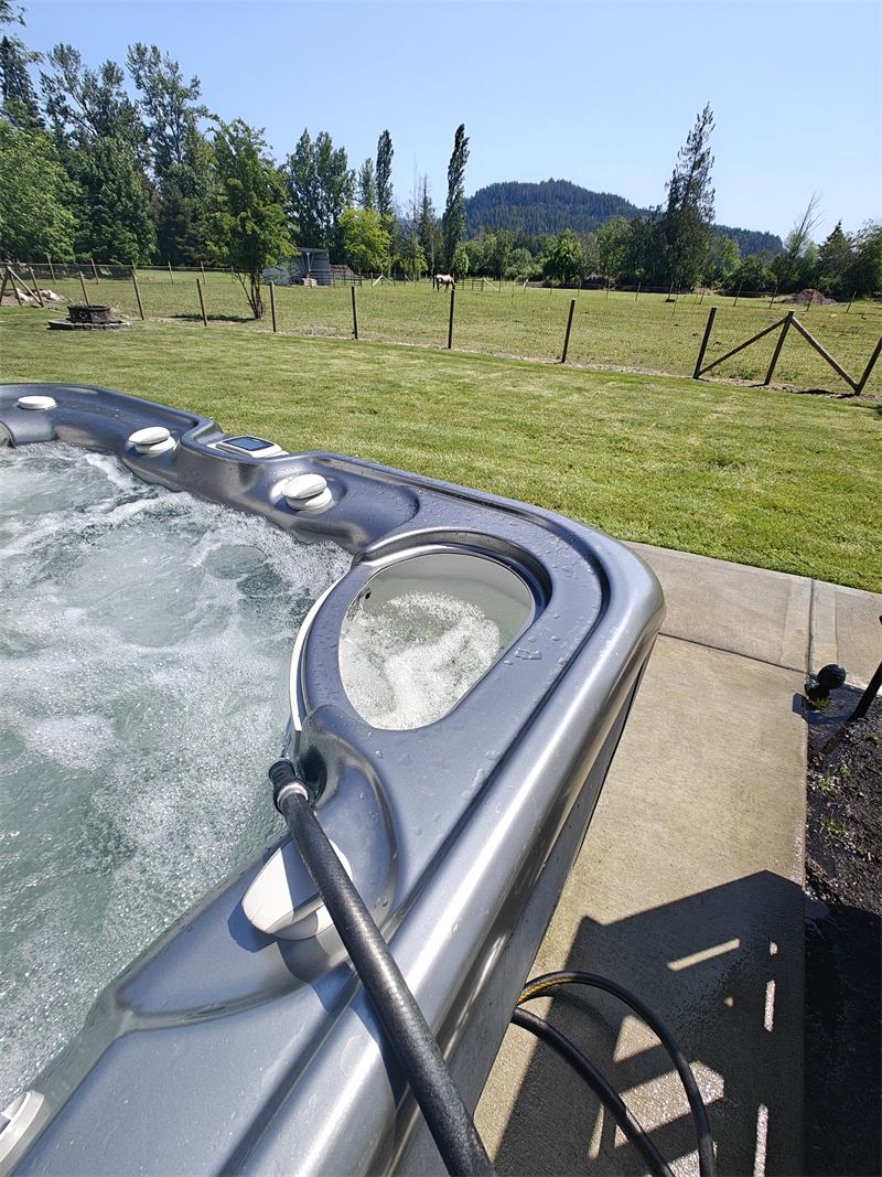 Hot tub with clean churning water in a farm backyard