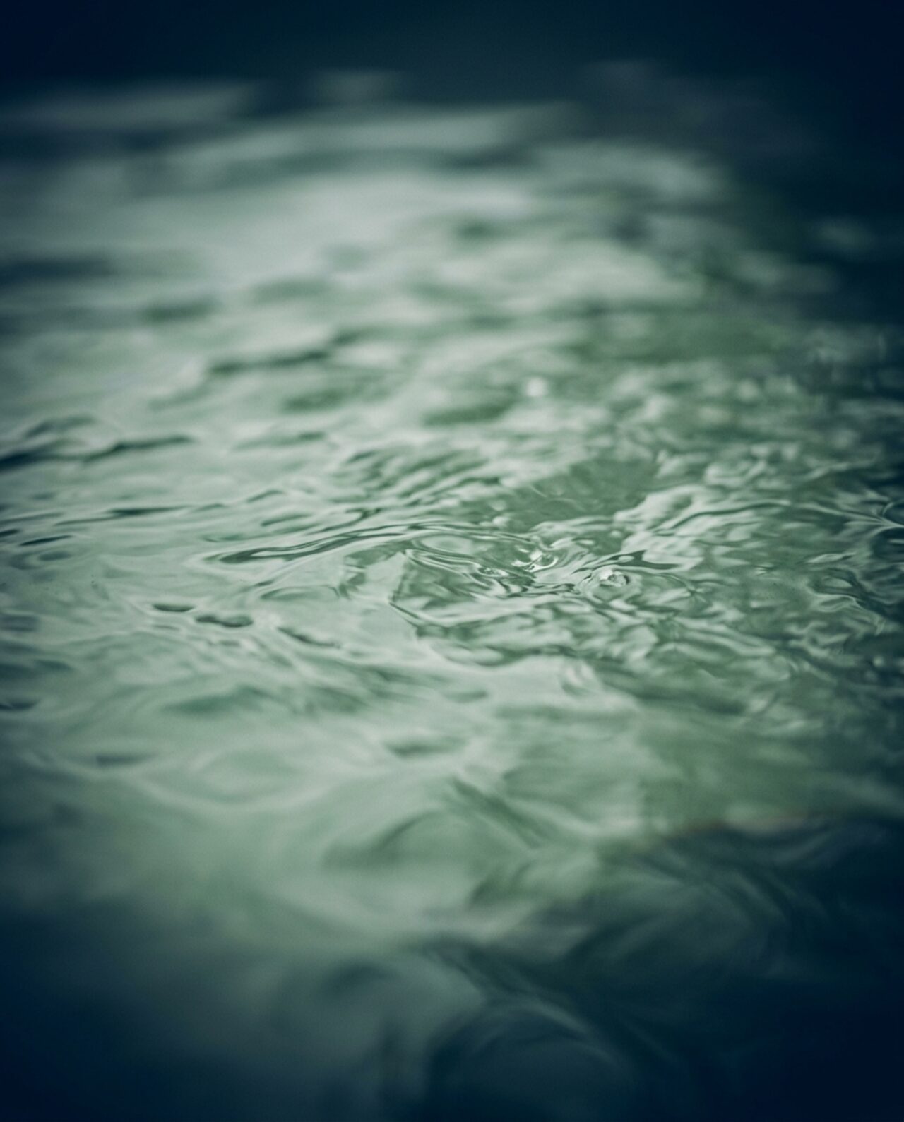 Stylized close-up illustration of green-tinted hot tub water